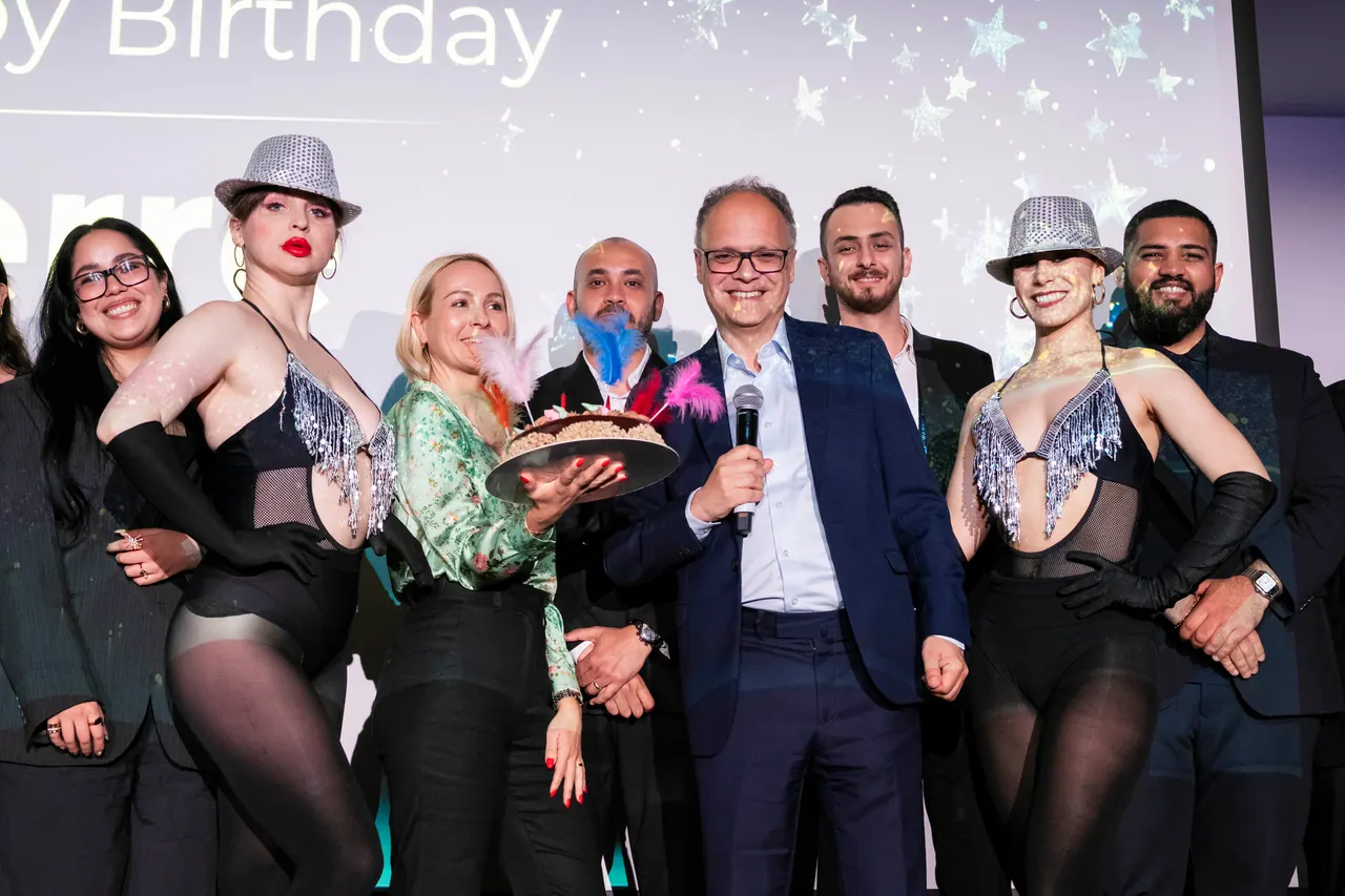 Performers and organisers celebrating on stage after a corporate gala