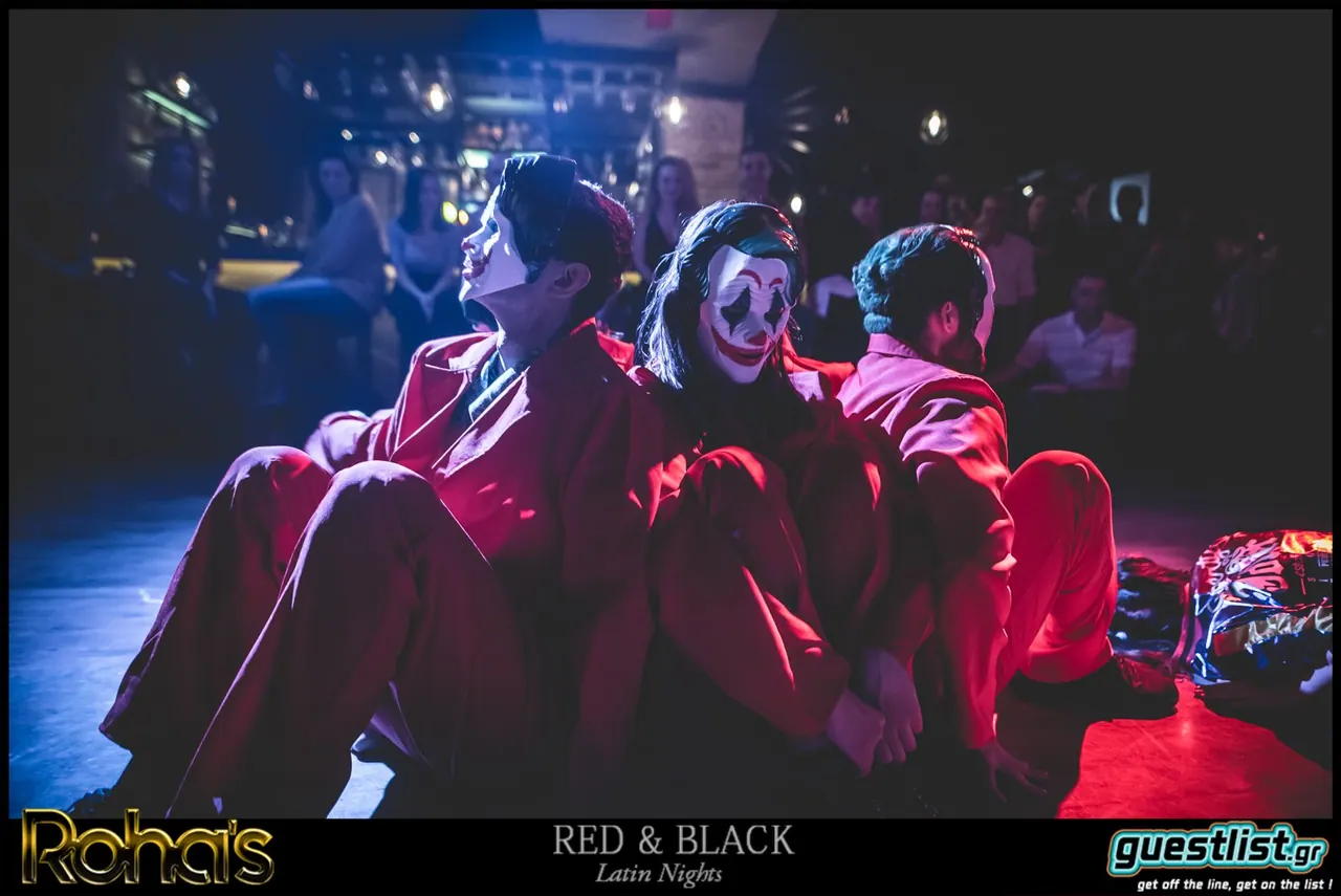 Themed show performers in red suits and masks at a party